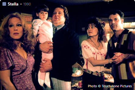 Group of five adults and a baby in a living room; still from the 1990 film Stella.