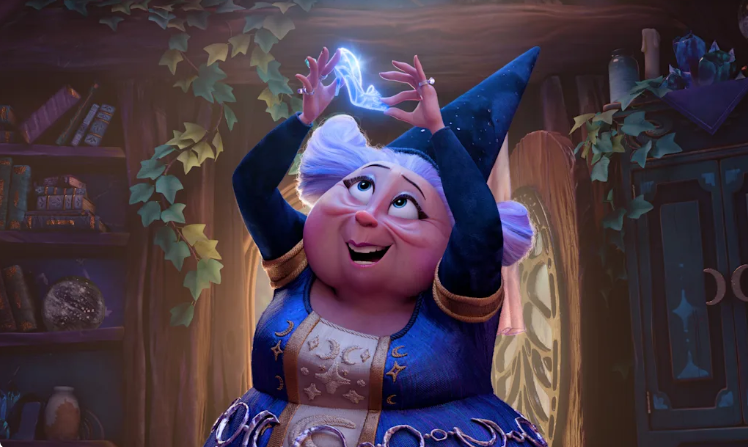 Happy elderly fairy in a blue dress casts a blue spell above her head in a cozy library.