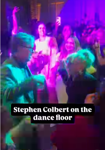 Crowd dancing on a neon-lit dance floor with purple and green lights; caption overlay reads 'Stephen Colbert on the dance floor'.