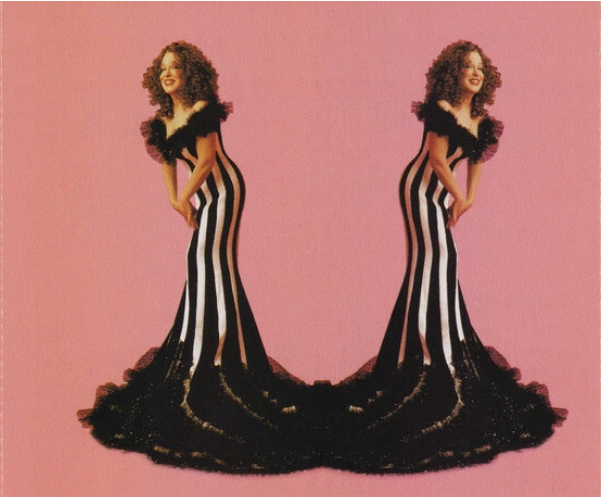 Two Bette Midler's wearing dramatic black-and-white striped mermaid gowns with long black train, posed in a mirror image on a pink background.