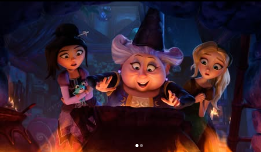2026-05-18_15-07-40 - bootleg betty Three animated characters gather around a glowing cauldron with a smiling witch in a dim cave.