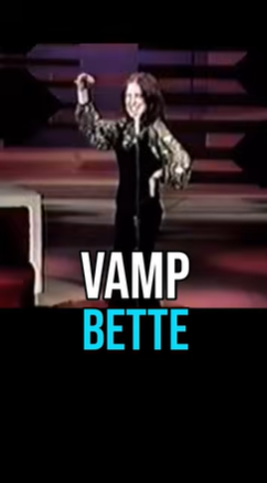 Stage performance by VAMPETTE: a woman in a metallic jacket raises her arm on a dark stage, with 'VAMP BETTE' text shown at the bottom.