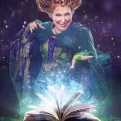 8b31a3b2045058060a32b331eafbe1eb - bootleg betty A woman in a green cloak casts a spell from an open glowing book, sparks rising from its pages in a magical scene.