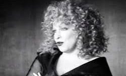 Black-and-white photo of a curly-haired woman with arms crossed; overlaid with Wind Beneath My Wings lyrics.