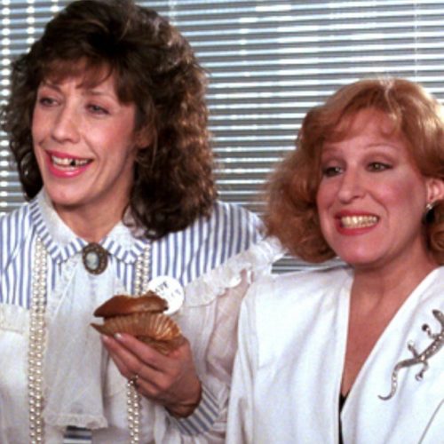 11312471_1627547210797104_2080035907_n-1 - bootleg betty Two smiling women pose together, with one holding a cupcake topped with frosting caught in a casual moment.