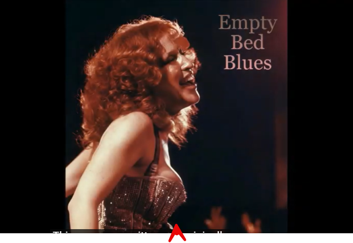 2026-08-05_12-51-56 - bootleg betty Female blues singer with red curly hair in a sparkly dress performing on stage; album title Empty Bed Blues in the top-right corner