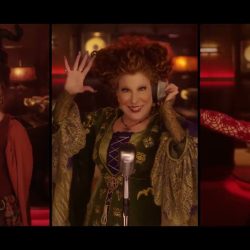 Three women in vintage costumes singing into microphones in a warm, red-lit studio.