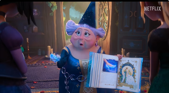 Grandmotherly wizard in a blue robe and hat reads from an open illustrated book to two visitors in a warmly lit, magical room.